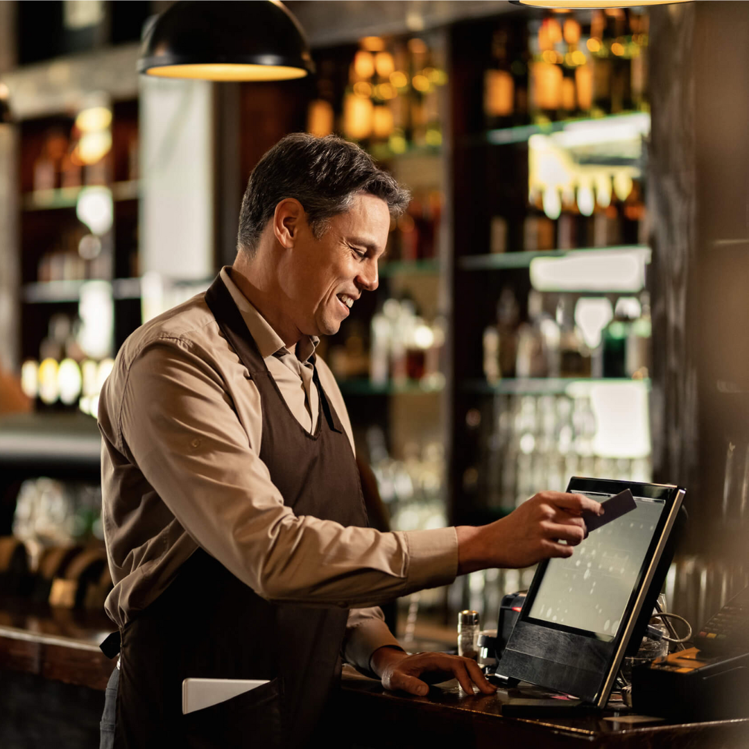 A bartender using SpotOn POS at their restaurant.